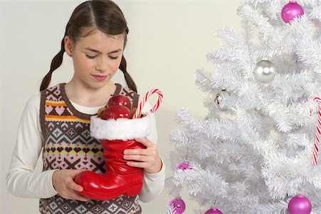 Girl holding a Santa Claus boot Stock Photo - Premium Royalty-Free, Code: 628-01279650