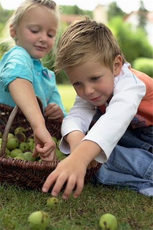 fruits basket low angle - Little girl and boy with a basket of limes, selective focus Stock Photo - Premium Royalty-Free, Code: 628-01279765