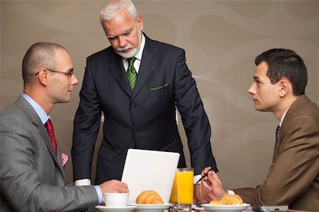 simsearch:628-01278542,k - Three businessmen having a meeting Stock Photo - Premium Royalty-Free, Code: 628-01279829