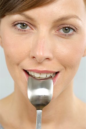 eat mouth closeup - Woman with spoon in mouth Stock Photo - Premium Royalty-Free, Code: 628-01494808