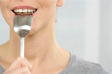 eat mouth closeup - Woman with spoon in mouth Stock Photo - Premium Royalty-Free, Code: 628-01494845