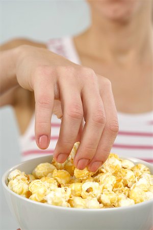 popcorn white background - Woman eating popcorn Stock Photo - Premium Royalty-Free, Code: 628-01494850