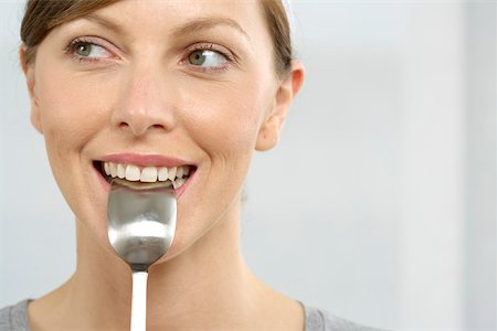 eat mouth closeup - Woman with spoon in mouth Stock Photo - Premium Royalty-Free, Code: 628-01494873