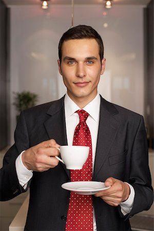 Businessman drinking a cup of coffee, portrait Stock Photo - Premium Royalty-Free, Code: 628-01495134