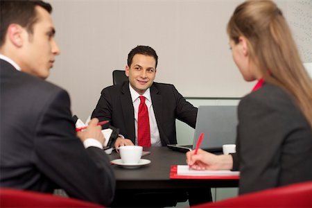 simsearch:628-01495138,k - Three businesspeople having a meeting Stock Photo - Premium Royalty-Free, Code: 628-01495130