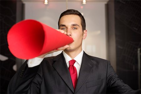 Businessman speaking through a megaphone Stock Photo - Premium Royalty-Free, Code: 628-01495195