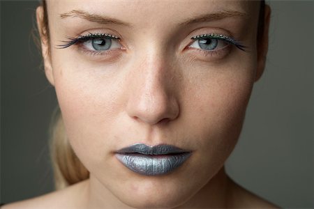 style futuristic - Young woman with silver colored lips (part of), close-up Stock Photo - Premium Royalty-Free, Code: 628-01495230