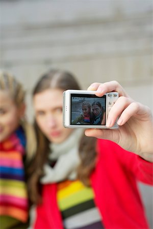 Two young women photographing themselves with a digital camera Stock Photo - Premium Royalty-Free, Code: 628-01495325