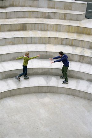 Young couple inline skating on step Stock Photo - Premium Royalty-Free, Code: 628-01495348