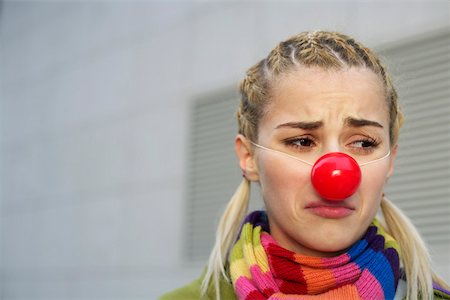 Cheerless young woman with red nose Fotografie stock - Premium Royalty-Free, Codice: 628-01495360