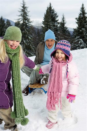 simsearch:6115-08104992,k - Daughters pulling father on sled Foto de stock - Royalty Free Premium, Número: 628-01495380