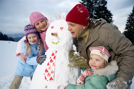 family with snowman - Family posing with snowman Stock Photo - Premium Royalty-Free, Code: 628-01495390