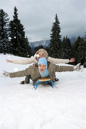 Laughing couple lying on a sled Stock Photo - Premium Royalty-Free, Code: 628-01495424