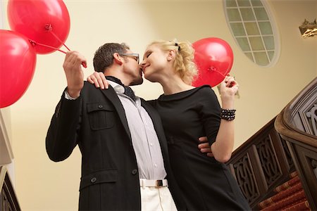 simsearch:628-01586462,k - Couple with balloons embracing each other on a staircase Stock Photo - Premium Royalty-Free, Code: 628-01586394