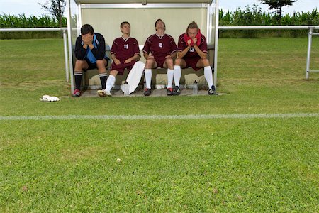 soccer goalie hands - Disappointed kickers sitting on substitutes' bench Stock Photo - Premium Royalty-Free, Code: 628-01586523