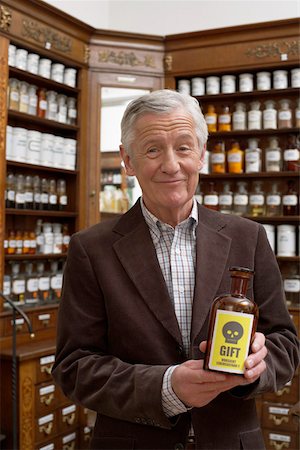 Man holding brown glass bottle with poison sign Stock Photo - Premium Royalty-Free, Code: 628-01586585