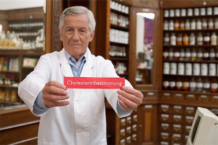 pharmacist with senior - Pharmacist holding cholesterol analysis sign Stock Photo - Premium Royalty-Free, Code: 628-01586582