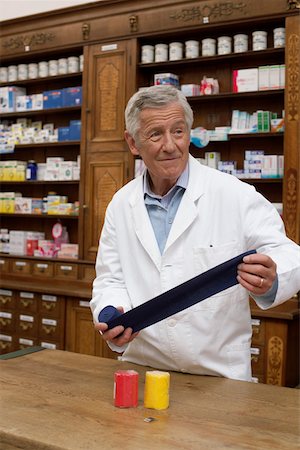 resistance band and men - Pharmacist winding up exercise band Stock Photo - Premium Royalty-Free, Code: 628-01586640