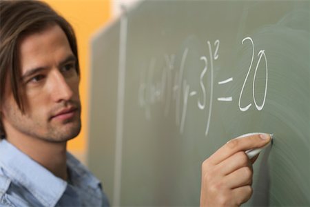 Man is writing prims on a board Stock Photo - Premium Royalty-Free, Code: 628-01586681