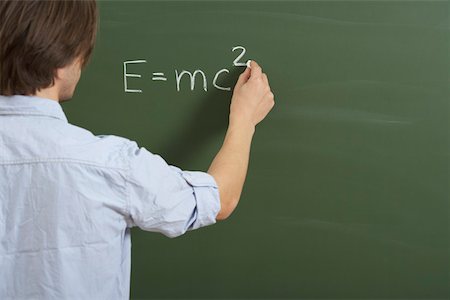 A man is writing a formula on a board Stock Photo - Premium Royalty-Free, Code: 628-01586711