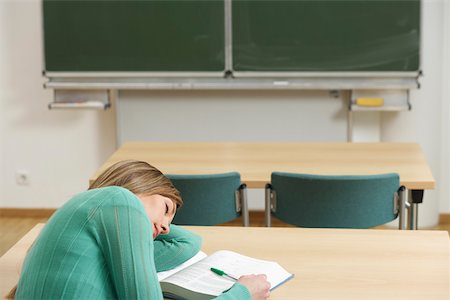 sleeping in a classroom - A woman is sleeping on her book Stock Photo - Premium Royalty-Free, Code: 628-01586745
