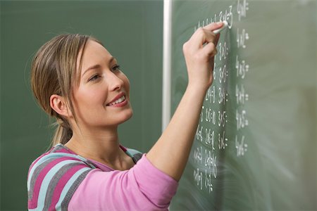 Woman is writing numbers on a board Stock Photo - Premium Royalty-Free, Code: 628-01586756