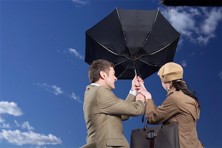 simsearch:628-01639098,k - Business couple under an umbrella in storm Stock Photo - Premium Royalty-Free, Code: 628-01639042