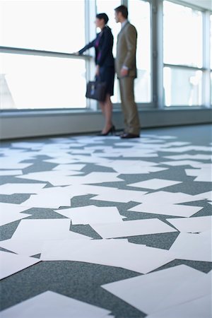 simsearch:628-01639098,k - Business couple in an empty office, sheets of paper on floor Stock Photo - Premium Royalty-Free, Code: 628-01639075