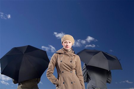 simsearch:628-01639098,k - Two businessmen with umbrellas, businesswoman looking at camera Stock Photo - Premium Royalty-Free, Code: 628-01639073