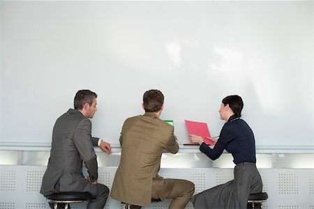 simsearch:628-01639098,k - Three businesspeople having a meeting Stock Photo - Premium Royalty-Free, Code: 628-01639087