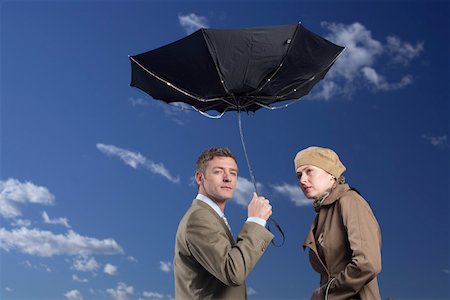 simsearch:628-01639098,k - Business couple under an umbrella in storm Stock Photo - Premium Royalty-Free, Code: 628-01639128