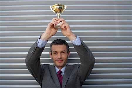 simsearch:628-01639078,k - Businessman holding a trophy above head Foto de stock - Sin royalties Premium, Código: 628-01639132