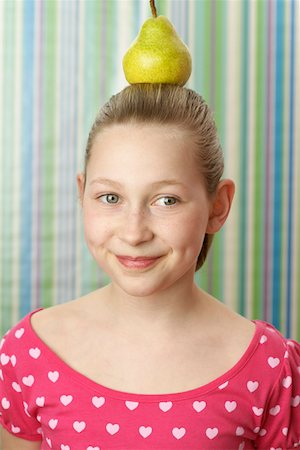Girl with pear on top Fotografie stock - Premium Royalty-Free, Codice: 628-01711936