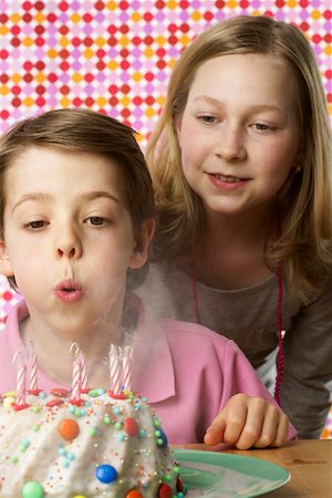 Boy blowing on candles Stock Photo - Premium Royalty-Free, Code: 628-01711946