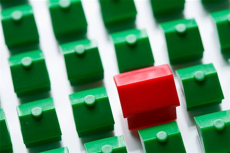 simsearch:628-01712179,k - Red plastic miniature-house standing amongst green ones Stock Photo - Premium Royalty-Free, Code: 628-01712187