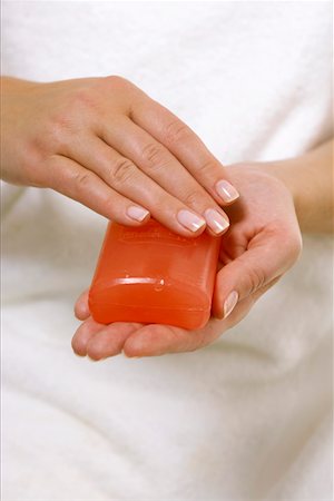 Woman holding a piece of soap between hands Stock Photo - Premium Royalty-Free, Code: 628-01712287