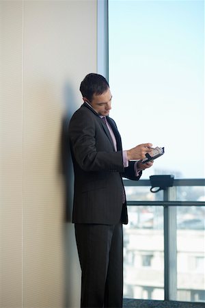 simsearch:640-02950930,k - Businessman phoning with a mobile phone while reading diary Stock Photo - Premium Royalty-Free, Code: 628-01712299