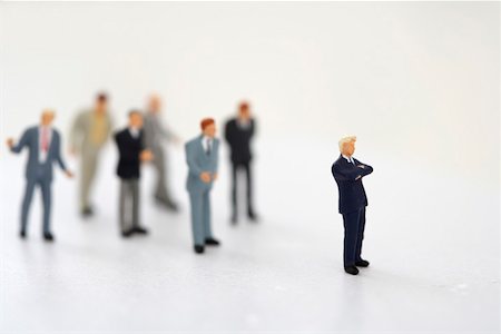 figurines businessman - Businessman figurine standing beside a group Stock Photo - Premium Royalty-Free, Code: 628-01712348