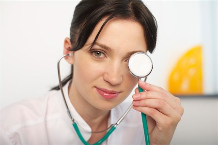 doctor eyes - Woman doctor covering eye with a stethoscope Stock Photo - Premium Royalty-Free, Code: 628-01836729