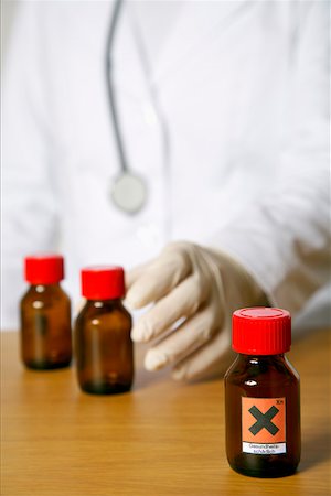 red liquid - Brown flask with toxic liquids, person in background Stock Photo - Premium Royalty-Free, Code: 628-01836747