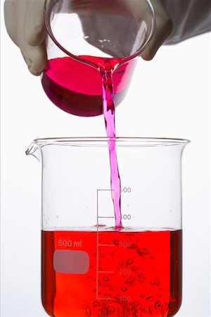 Pouring of red liquid into a beaker Stock Photo - Premium Royalty-Free, Code: 628-01836766