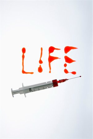 Red written word LIFE and a syringe Stock Photo - Premium Royalty-Free, Code: 628-01836761