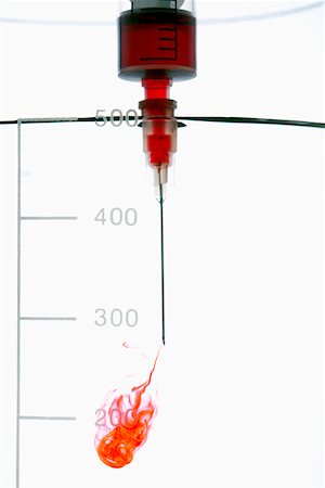 Injection of red liquid into water Stock Photo - Premium Royalty-Free, Code: 628-01836775