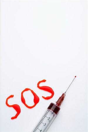 sos image - Red written word SOS and a syringe Stock Photo - Premium Royalty-Free, Code: 628-01836784