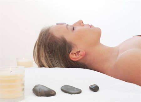 skin treatment medical - Mid adult woman receiving hot stone therapy treatment Stock Photo - Premium Royalty-Free, Code: 628-02062555