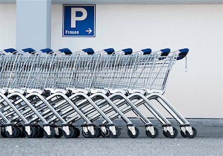 shopping cart not food - Row of shopping trolleys and a sing for women`s parking spot Stock Photo - Premium Royalty-Free, Code: 628-02062600