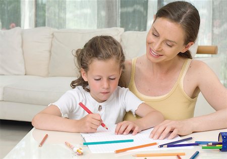 Mother and daughter drawing in living room Stock Photo - Premium Royalty-Free, Code: 628-02062733