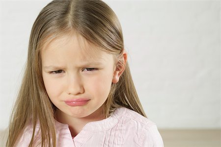 sad little girl - Cheerless girl looking at camera Stock Photo - Premium Royalty-Free, Code: 628-02197927