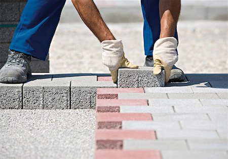 Construction worker setting paving stones Stock Photo - Premium Royalty-Free, Code: 628-02198026