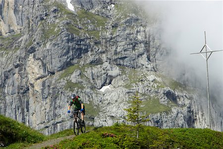 Mountainbike rider in front of a rock face Stock Photo - Premium Royalty-Free, Code: 628-02228190